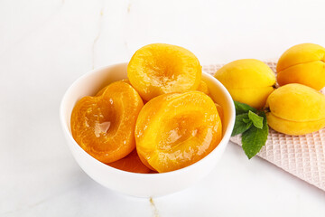 Few canned aprocots in the bowl