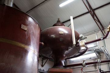 Double distillation process of cognac spirit in Charentias copper alambic still pots and boilers in...