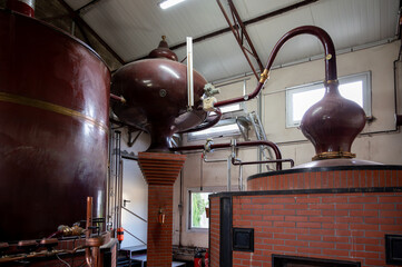 Double distillation process of cognac spirit in Charentias copper alambic still pots and boilers in...