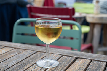 Tasting of Bordeaux white wine, right bank of Gironde Estuary, France. Glasses of white sweet French wine served in outdoor restaurant on oysters farm in Gujan-Mestras, Arcachon bay