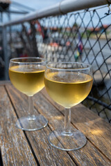 Tasting of Bordeaux white wine, right bank of Gironde Estuary, France. Glasses of white sweet French wine served in outdoor restaurant on oysters farm in Gujan-Mestras, Arcachon bay