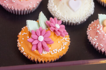 Colorful marzipan almongs cakes with decorative marzipan flowers