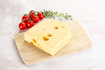 Maasdam cheese brick over board
