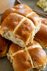 Traditional British Easter food, fresh baked cross buns with raisins or apples