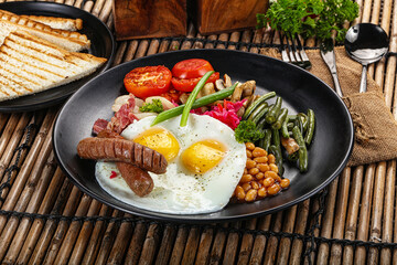 Traditional Engrlish breakfast with egg  and sausages