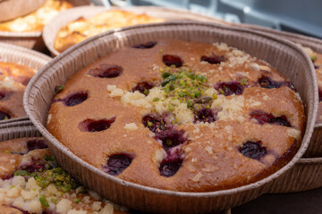 Sweet pastries, rustic apple cakes, cherry, almond cakes on food market in London, UK