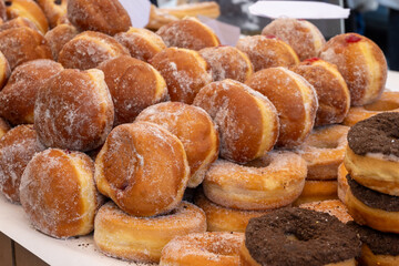 Stuffed Berlin balls with cream or fruit jam for sale on food market