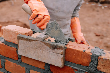 Workers are cementing bricks on a baguna with bricks in the background and shovels in hand, lampung...