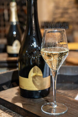 Tasting of grand cru sparkling brut white wine with bubbles champagne by old champagne caves in grand cru wine producer small village Cramant, Champagne, France