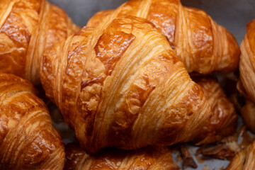 Breakfast in France, fresh baked butter croissants in artisanal bakery in Paris, France