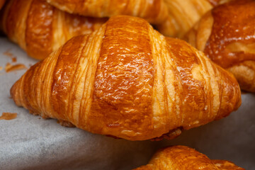 Breakfast in France, fresh baked butter croissants in artisanal bakery in Paris, France