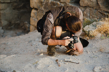 Concept for a history channel. An archaeologist takes a photo of a found artifact