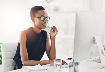 Black woman, computer and office with working as creative director for magazine, publication or company. Female person, African and typing with thinking, happy and job for deadline, project and brief