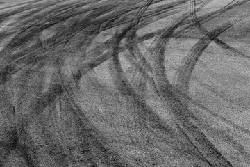 Aerial view Textured background vehicle trace on asphalt road, Tire print texture background transport, Car tire mark burnout texture and background, Tire mark on the asphalt road race track.