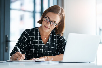 Office, woman and laptop or writing in notebook for proposal, application and requirement to...