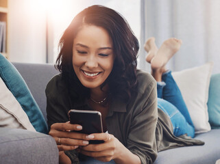 Happy woman, relax and cellphone on couch for social media, reading and streaming in home. Blog, smile and female person in living room or lounge for connection, scroll and mobile app for networking