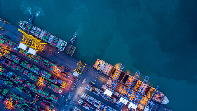 Aerial view container cargo ship  at commercial sea port, Global business logistic import export transportation international by container cargo ship, Container cargo ship freight shipping at night.