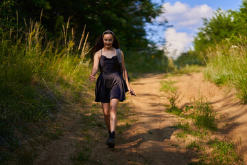 Young woman on a dirt road in the forest