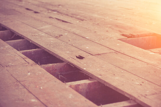 Declination of old wooden balcony or platform.Interior of a dirty and dilapidated room in an abandoned house.