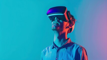 Cheerful young man experiencing virtual reality with a sleek VR headset, standing in front of a bright solid cyan background with copy space