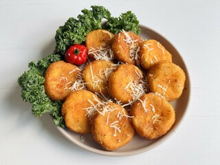 Home made potato croquettes - mashed potatoes balls with grated mozzarella cheese seasoned with...