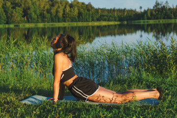 Beautiful woman exercising near the lake
