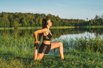 Beautiful woman exercising near the lake