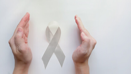 Hand protect a White light pearl color ribbon for Lung cancer awareness and Multiple Sclerosis,...
