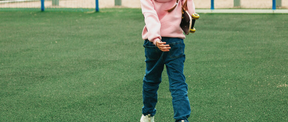 Beautiful hipster girl with skateboard in skate park
