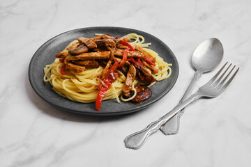 Plate with spaghetti with mushrooms and pork