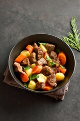 Beef stew with potatoes, carrots and greens