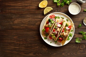 Tacos with vegetables and meat on wooden background