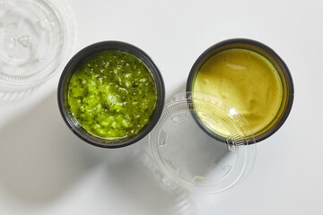 two sauces in plastic cups