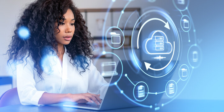 African woman typing on laptop, cloud service hologram and files backup