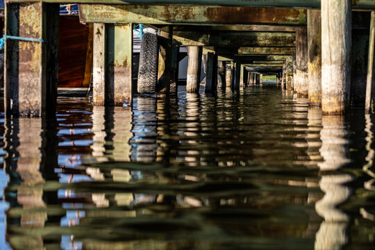 Stockholm, Sweden An underside or water-level view of a  wooden dock on Lake Malaren.