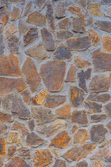 A wall of stones held together with cement. Abstract background.