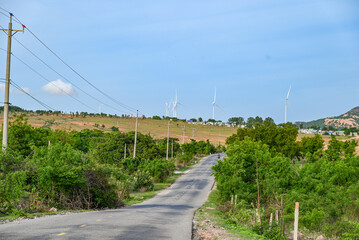 A road in central Vietnam surrounded by vast fields of wind turbines