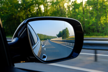look in the rear view mirror of a car