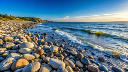 Serene coastal landscape featuring smooth grey stones scattered along a tranquil shoreline with gentle waves and clear blue sky.