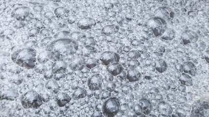 The brown foam floating on the surface of the water