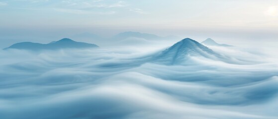Mesmerizing aerial view of mountain peaks emerging through a vast, fog-covered landscape during sunrise, creating a tranquil and ethereal scene.