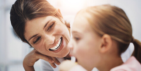 Mother, child and brushing teeth in home bathroom, teaching and oral hygiene with girl for wellness with family. Dental health, cleaning and fresh for breath, routine and plaque prevention in morning