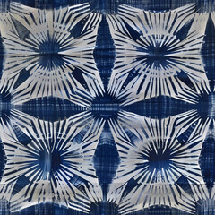 Abstract seamless pattern with white and blue radial shapes on a plaid dark background