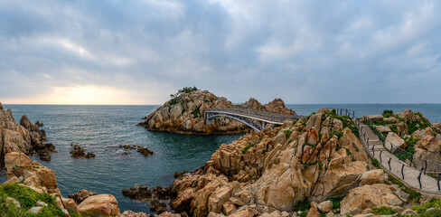 Summer and morning view of deck trail and bridge on the sea with seaside rocks against horizon at Daewangam Rock near Dong-gu, Ulsan, South Korea
