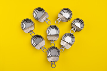 View from above. Recycling concept. Open heart-shaped cans. Recycling materials. color background