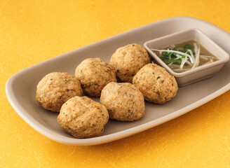 Crispy fried dace balls with clamsserved in dish isolated on background side view of hong kong fasfood
