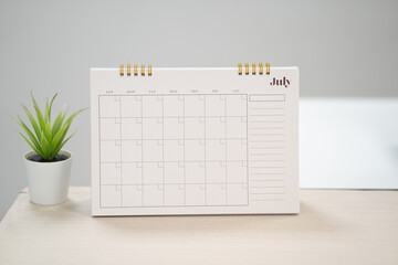 Desk calendar for July  on the table with copy space concept.