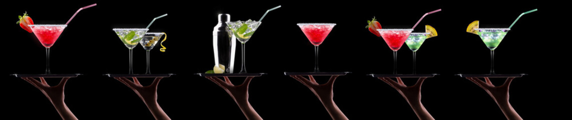 Hand holding tray with different alcohol cocktails isolated on black background