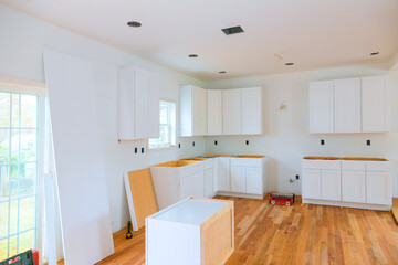 During construction of new house, custom kitchen cabinets are installed in kitchen