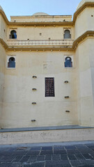 A picture of a building in Udaipur palace which shows the beautiful architecture high is unique to Rajasthan
